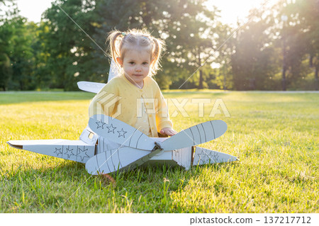 Pretend play child. Girl aviation pilot toy. Summer fun outdoor cardboard. 137217712