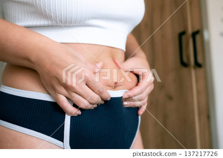 Curvy woman. Natural belly fat close up. Body acceptance concept Curvy woman. Natural belly fat close up. Body acceptance concept 137217726