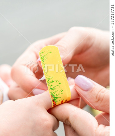 Child finger protection. Toddler skin covered with bandage closeup. Safety awareness concept. 137217731
