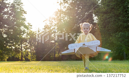 Pretend play child. Girl aviation pilot toy. Summer fun outdoor cardboard. Pretend play child. Girl aviation pilot toy. Summer fun outdoor cardboard. 137217752