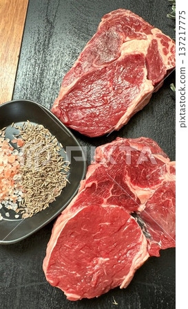 Three Raw Steaks Arranged With Seed Bowl On Wooden Counter, Meal Prep Ritual By Health Cook, Portion Control And Protein Focus For Weekly Planning, Neat Culinary Layout Three Raw Steaks Arranged With Seed Bowl On Wooden Counter, Meal Prep Ritual By Health Cook, Portion Control And Protein Focus For Weekly Planning, Neat Culinary Layout 137217775