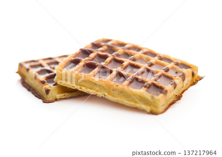 Sweet waffles with chocolate isolated on white background. Sweet waffles with chocolate isolated on white background. 137217964