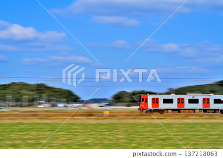 A red train running through the countryside 137218063