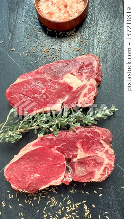 Uncooked Sirloin On Slate Ready To Cook, Fresh Raw Sirloin Cut Seasoned And Placed On Slate, Uncooked Beef Sirloin With Rosemary And Pink Salt Prepared For Grilling On Slate 137218319