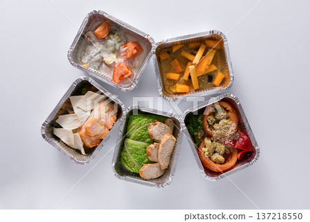 Healthy food delivery. Take away of natural fitness dishes for diet. Daily meals in foil boxes on white background 137218550