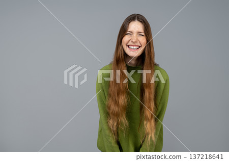 Cute young woman in green clothes having fun and laughing Cute young woman in green clothes having fun and laughing 137218641