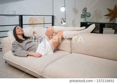 Cute young woman resting at home and feeling cheerful and carefree 137218692