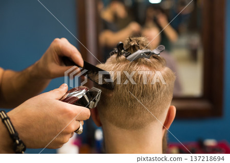 Barber beard with trimmer at barbershop, closeup of client's head. Male Barbershop 137218694