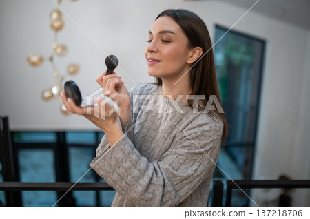 Pretty young woman doing make up and looking excited 137218706