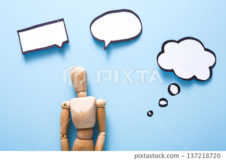 Handcrafted wooden man figure mannequin model dummy doll with blank speech bubble on blue background,objects, nobody 137218720