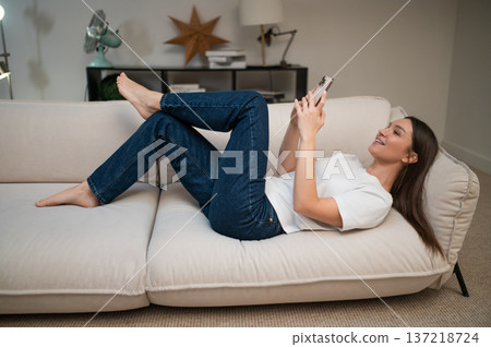 Cheerful pretty young woman making selfie and feeling flirty Cheerful pretty young woman making selfie and feeling flirty 137218724