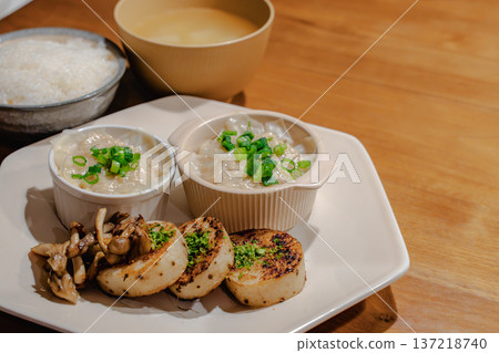 Japanese set meal on a wooden table with copy space. Dinner of rice, miso soup and side dishes Japanese set meal on a wooden table with copy space. Dinner of rice, miso soup and side dishes 137218740
