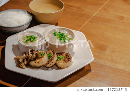 Japanese set meal on a wooden table: rice, miso soup, steamed food, and grilled radish dinner Japanese set meal on a wooden table: rice, miso soup, steamed food, and grilled radish dinner 137218743