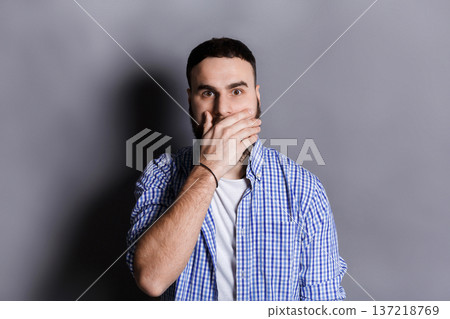 Surprised bearded man covering mouth with hand. Keep silence. Gossip, shock concept. Surprised bearded man covering mouth with hand. Keep silence. Gossip, shock concept. 137218769
