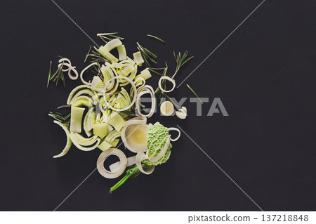 Cooking healthy food. Sliced and chopped leek on dark background Cooking healthy food. Sliced and chopped leek on dark background 137218848