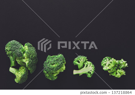 Stages of cutting broccoli on black background. Chopping fresh fruit, cooking healthy food Stages of cutting broccoli on black background. Chopping fresh fruit, cooking healthy food 137218864