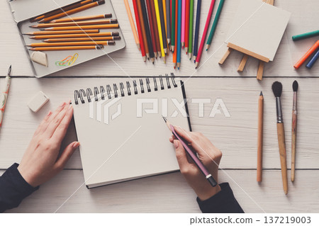 Draw in sketchbook. Creative artist workspace top view. Background of painting, art stationery 137219003