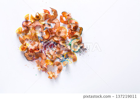 Wooden colored pencil sharpening shavings pile on white isolated background, top view, flat lay, copy space Wooden colored pencil sharpening shavings pile on white isolated background, top view, flat lay, copy space 137219011