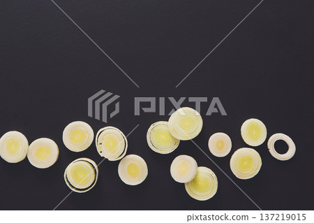 Cooking healthy food. Sliced leek border on dark background 137219015