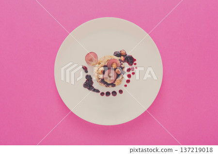 Healthy breakfast, dieting and detox concept - wholegrain fresh oatmeal porridge on plate with fruits, berries and nuts on pink background, top view. 137219018