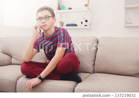 Teenager has phone talk in living room at home, chat with friend, communication and conversation 137219032