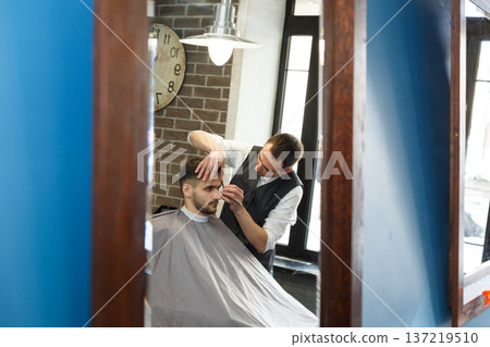 Men barbershop. Making modern hairstyle in male hair salon 137219510