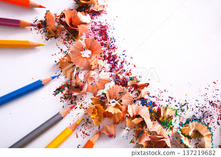 Drawing tools background. Lot of colorful pencils frame with sawdust and shavings on white, copy space, flat lay Drawing tools background. Lot of colorful pencils frame with sawdust and shavings on white, copy space, flat lay 137219682