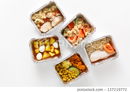 Five aluminum containers display a variety of healthy meal prep options. Each container features different ingredients, including vegetables and proteins, arranged for balanced meals. Five aluminum containers display a variety of healthy meal prep options. Each container features different ingredients, including vegetables and proteins, arranged for balanced meals. 137219772