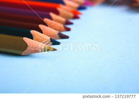 Wooden colorful pencils in row on blue background, close-up, objects, shallow depth of field 137219777