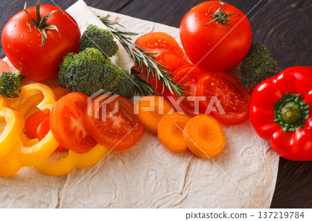Cooking healthy vegetarian food background. Fresh organic vegetables on pita bread, natural food, close up. Cooking healthy vegetarian food background. Fresh organic vegetables on pita bread, natural food, close up. 137219784