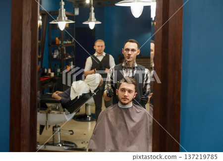 Client and barber looking at mirror. Hipster barbershop for men. 137219785
