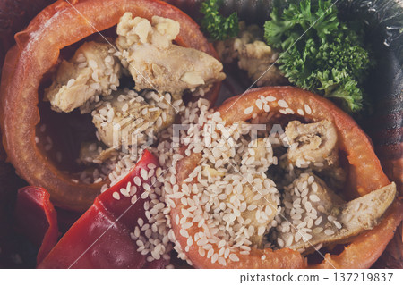 Healthy lunch in foil container. Healthy food take away and delivery. Bell pepper stuffed with chicken, broccoli, sesame, closeup Healthy lunch in foil container. Healthy food take away and delivery. Bell pepper stuffed with chicken, broccoli, sesame, closeup 137219837