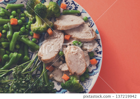 Healthy food, diet nutrition. Green steamed vegetables and slices of chicken on bright geometric background, top view, copy space Healthy food, diet nutrition. Green steamed vegetables and slices of chicken on bright geometric background, top view, copy space 137219942