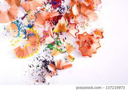 Wooden colorful pencil sharpening shavings on white as abstract background. Art and education Wooden colorful pencil sharpening shavings on white as abstract background. Art and education 137219973