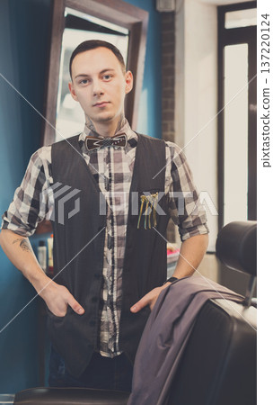 Barber wait for client. Young professional haitstylist in male barbershop Barber wait for client. Young professional haitstylist in male barbershop 137220124