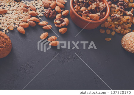 Healthy food, nuts and oat on dark table background, copy space. Healthy food, nuts and oat on dark table background, copy space. 137220170