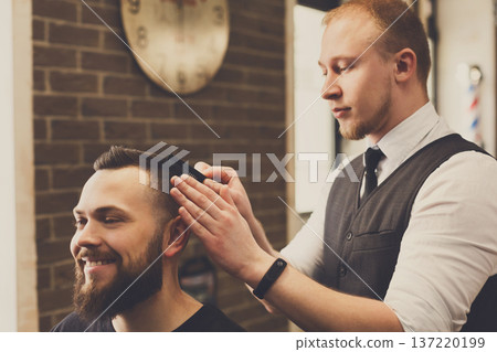 Barber make haircut with scissors in barbershop. Hairstyle in male hair salon Barber make haircut with scissors in barbershop. Hairstyle in male hair salon 137220199
