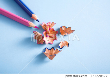 Stationary supplies - wooden color pencil shavings on blue background, flat lay, copy space, close-up Stationary supplies - wooden color pencil shavings on blue background, flat lay, copy space, close-up 137220327