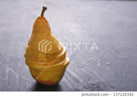 Healthy food, fruit background. Sliced pear on silver background, selective focus, diet and vegetarian concept Healthy food, fruit background. Sliced pear on silver background, selective focus, diet and vegetarian concept 137220392