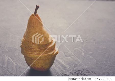 Sliced pear on silver background, selective focus, healthy food, diet and vegetarian concept Sliced pear on silver background, selective focus, healthy food, diet and vegetarian concept 137220400