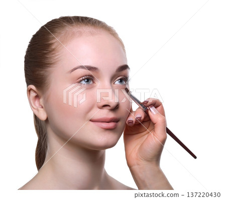 Applying makeup for beauty model with eyeshadow palette, isolated on white background 137220430