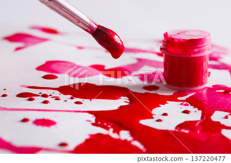 Creating watercolor painting. Brush and paint jar, bright red drops on paper texture background. Modern art backdrop with copy space Creating watercolor painting. Brush and paint jar, bright red drops on paper texture background. Modern art backdrop with copy space 137220477