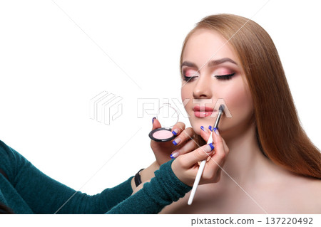Make-up artist applying blush makeup for beauty model with palette, isolated on white background Make-up artist applying blush makeup for beauty model with palette, isolated on white background 137220492