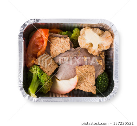 Healthy eating concept. Lunch in foil container, take away of restaurant food. Weight loss diet. Steamed veal with boiled cauliflower, broccoli and fresh tomato on white background, closeup, isolated Healthy eating concept. Lunch in foil container, take away of restaurant food. Weight loss diet. Steamed veal with boiled cauliflower, broccoli and fresh tomato on white background, closeup, isolated 137220521