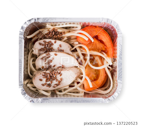 Healthy lunch in foil container. Healthy food take away and delivery. Durum wheat pasta, steamed turkey, fresh vegetables and flax seeds in box on white background, closeup, isolated 137220523