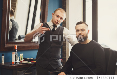 Thankful bearded client and professional stylish barber. Hairstylist and satisfied customer at barbershop Thankful bearded client and professional stylish barber. Hairstylist and satisfied customer at barbershop 137220553