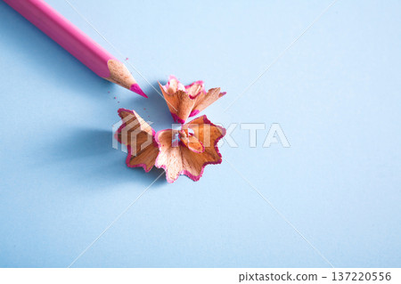 Stationary supplies - wooden color pencil shavings on blue background, flat lay, copy space, close-up Stationary supplies - wooden color pencil shavings on blue background, flat lay, copy space, close-up 137220556