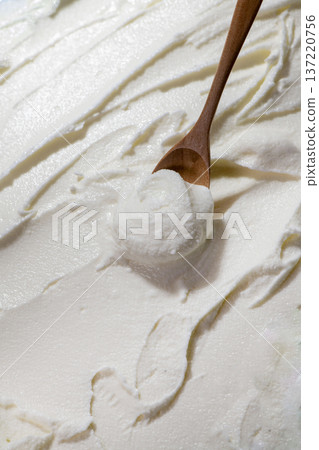 Scoop vanilla ice cream with a spoon Scoop vanilla ice cream with a spoon 137220756