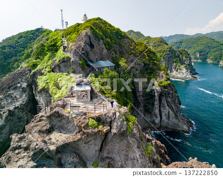 Drone shot of Irozaki Ocean Park. The beautiful white Irozaki Lighthouse and Ishimuro Shrine are located on the cliffs at the tip of the cape. Drone shot of Irozaki Ocean Park. The beautiful white Irozaki Lighthouse and Ishimuro Shrine are located on the cliffs at the tip of the cape. 137222850