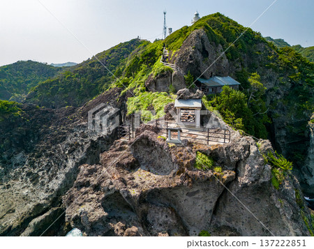 Drone shot of Irozaki Ocean Park. The beautiful white Irozaki Lighthouse and Ishimuro Shrine are located on the cliffs at the tip of the cape. Drone shot of Irozaki Ocean Park. The beautiful white Irozaki Lighthouse and Ishimuro Shrine are located on the cliffs at the tip of the cape. 137222851
